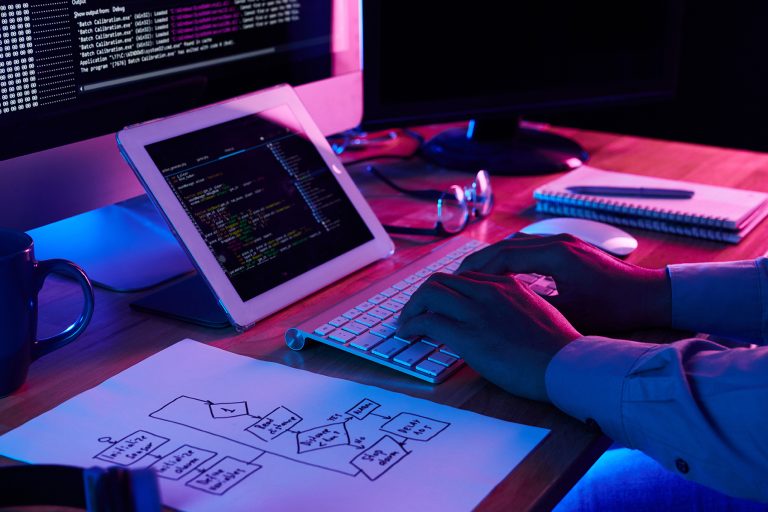 Close-up image of web designer working at his desk in office