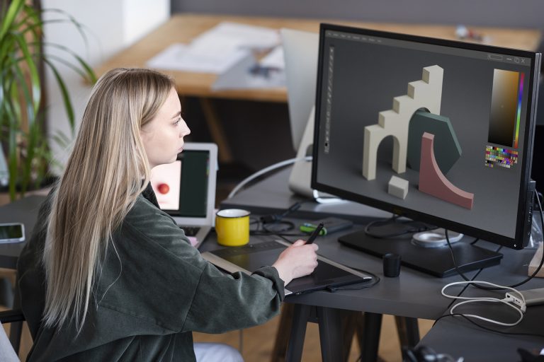 young woman working on a 3d design on her computer
