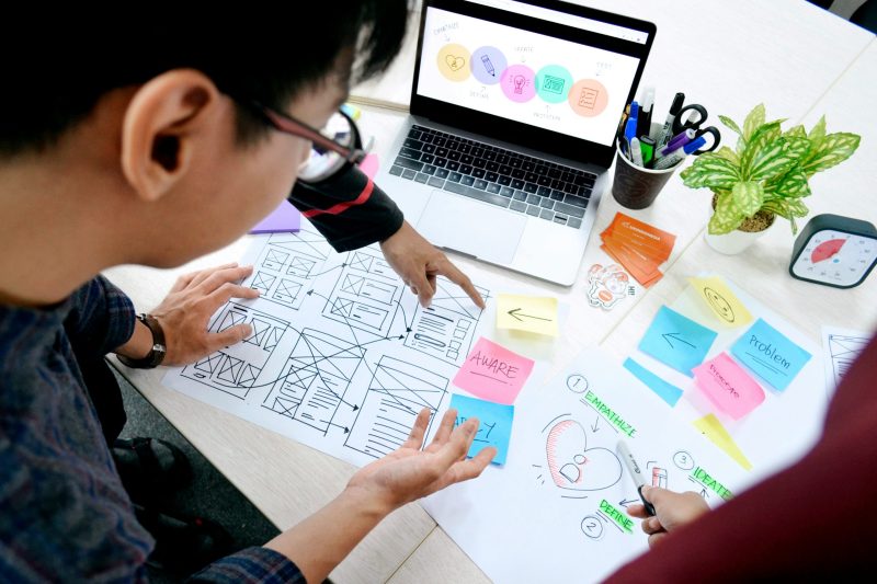 User Experience (UX) Designer​ discussing wireframe with team member